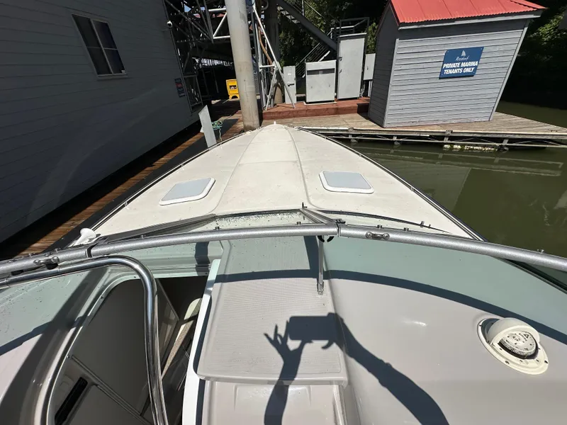 Slide: The Image of 2000 Formula 330 SS boat docked near a marina building. - 24