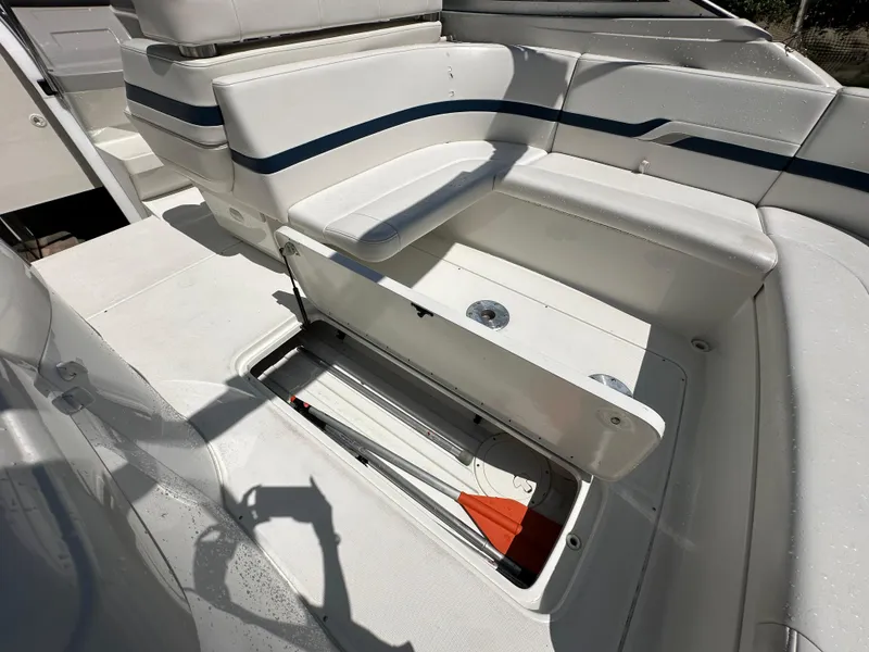 Slide: The Image of 2000 Formula 330 SS boat interior with open storage compartment and white seating. - 26