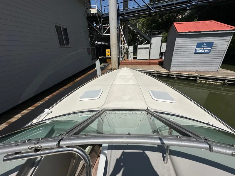 Slide: The Image of 2000 Formula 330 SS boat docked near a marina building. - 29