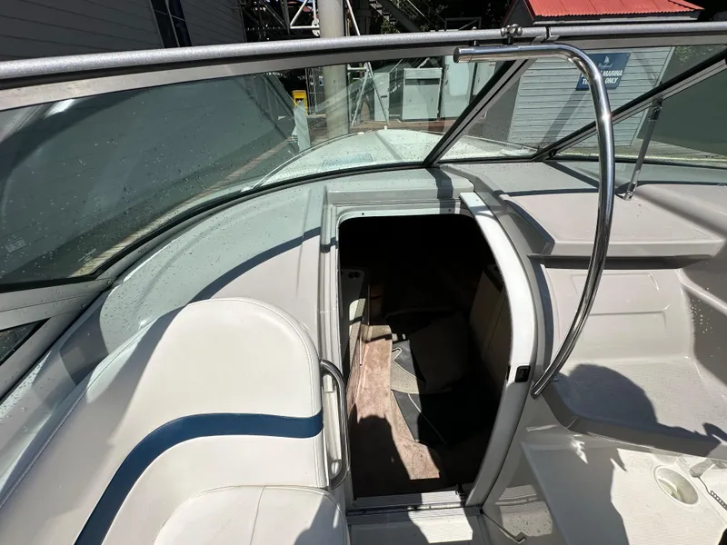 Slide: The Image of 2000 Formula 330 SS boat interior with open cabin entrance, white seating, and glass windshield. - 31