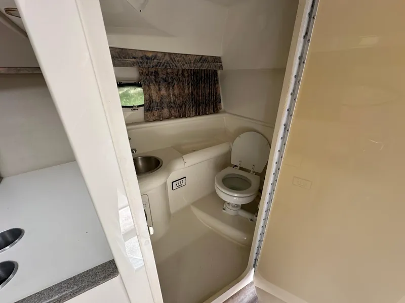 Slide: The Image of Interior of 2000 Formula 330 SS boat bathroom with sink and toilet. - 43