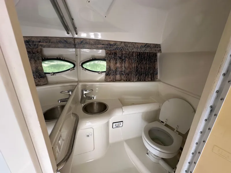 Slide: The Image of Interior of 2000 Formula 330 SS boat bathroom with sink and toilet. - 44