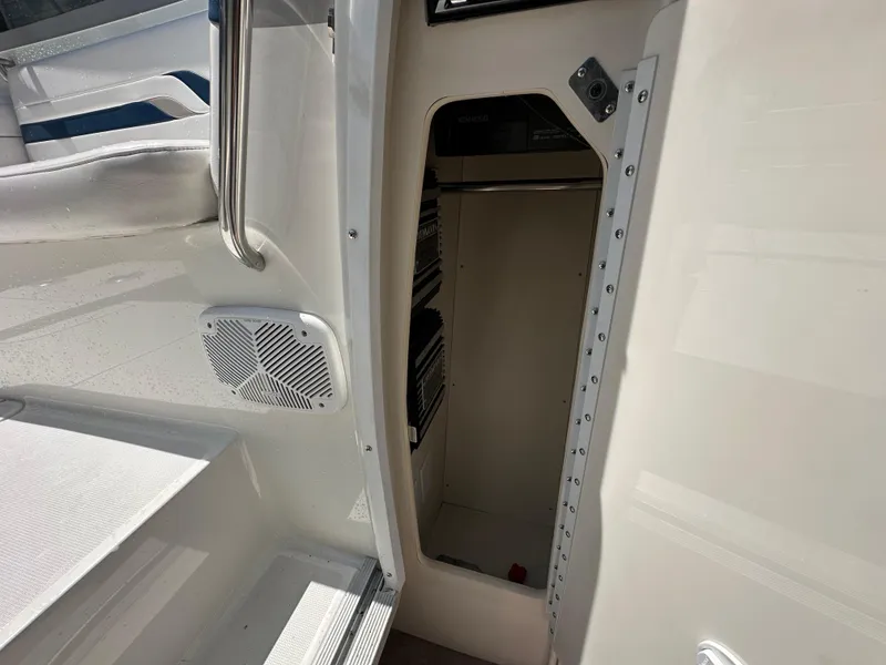 Slide: The Image of 2000 Formula 330 SS boat interior with open storage compartment and speaker. - 47
