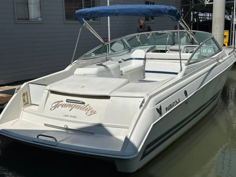 Slide: The Image of 2000 Formula 330 SS boat with blue canopy docked in marina. - 5