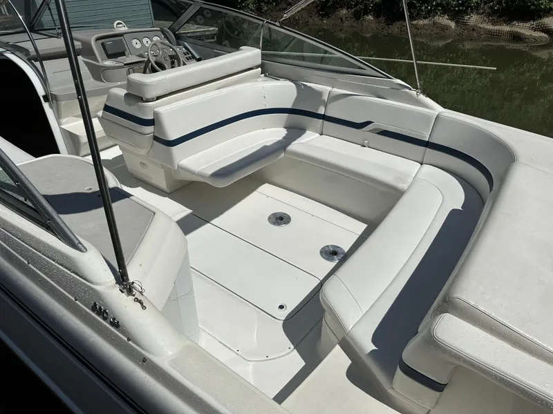 Slide: The Image of 2000 Formula 330 SS boat interior with white seating and steering console. - 8