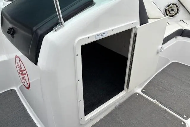 Slide: The Image of 2015 Yamaha SX192 boat storage compartment with open door, showcasing interior space. - 13