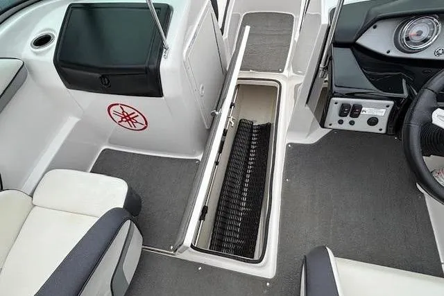 Slide: The Image of 2015 Yamaha Boats SX192 interior with open storage compartment and seating. - 17
