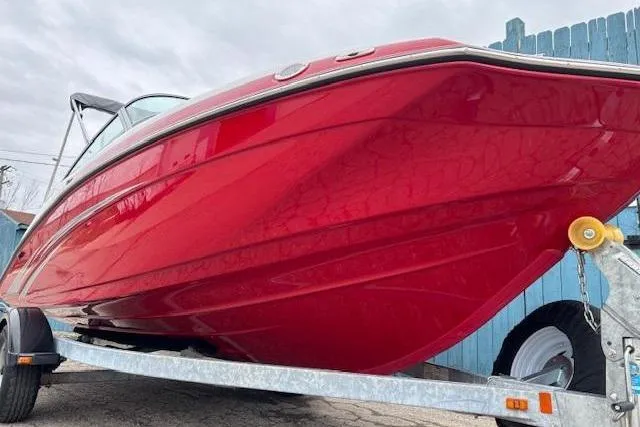 Slide: The Image of 2015 Yamaha Boats SX192 in vibrant red on a trailer, side view. - 2