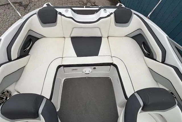 Slide: The Image of 2015 Yamaha Boats SX192 interior seating, featuring white and black cushioned seats. - 23