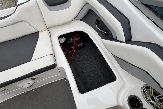 Slide: The Image of 2015 Yamaha Boats SX192 interior storage compartment with battery and seating. - 24