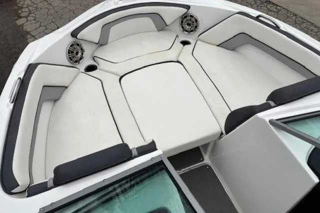 Slide: The Image of 2015 Yamaha Boats SX192 interior with white seating and speaker system. - 9