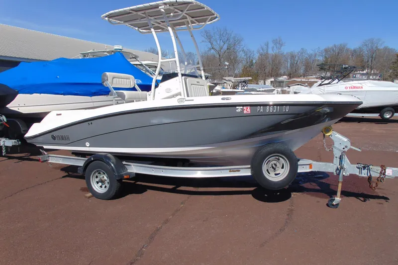 The Image of 2016 Yamaha Boats 190 FSH Sport on trailer, parked outdoors. - 1