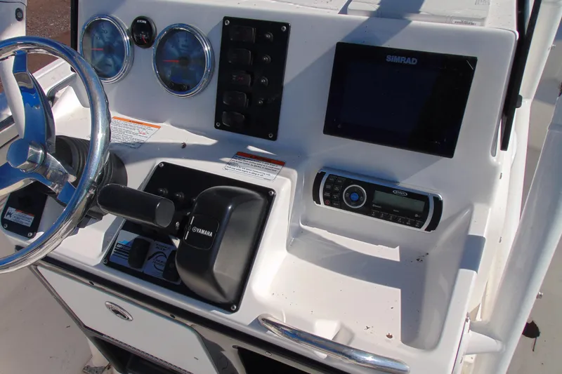 Slide: The Image of 2016 Yamaha Boats 190 FSH Sport dashboard with steering wheel and control panel. - 10