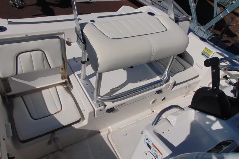Slide: The Image of 2016 Yamaha Boats 190 FSH Sport interior with white seating and control panel. - 11