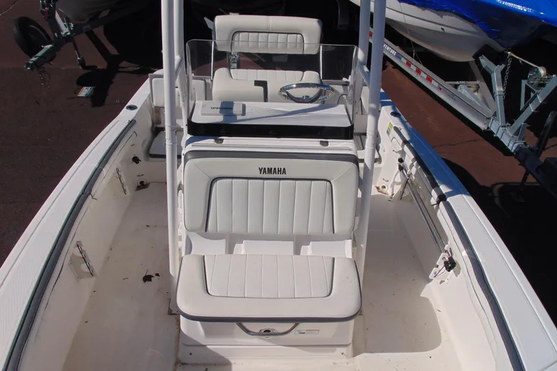 Slide: The Image of 2016 Yamaha Boats 190 FSH Sport interior with white seating and steering console. - 13