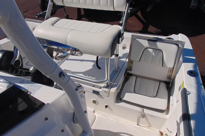 Slide: The Image of 2016 Yamaha Boats 190 FSH Sport interior with white seating and steering console. - 14