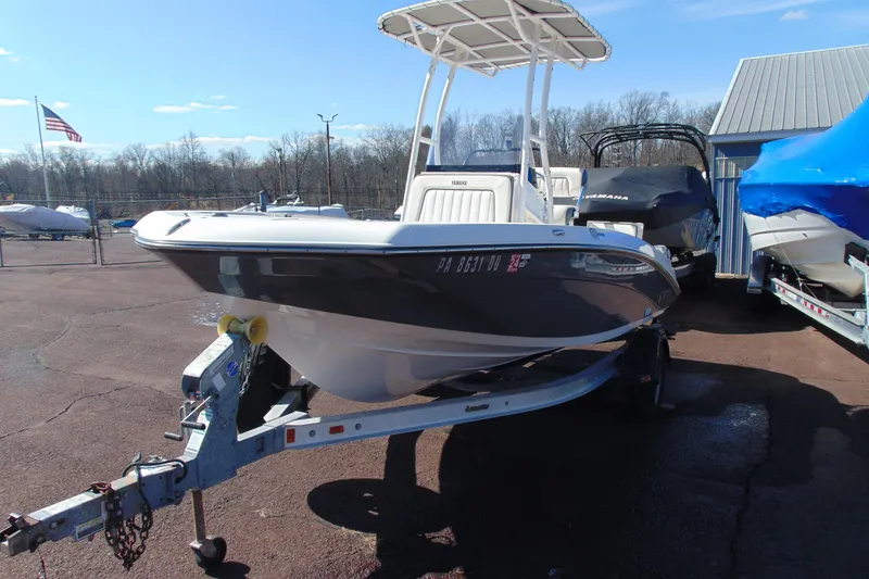 Slide: The Image of 2016 Yamaha Boats 190 FSH Sport on trailer, parked outdoors under clear sky. - 2