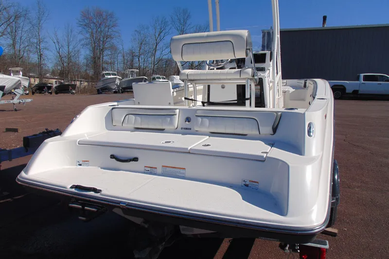 Slide: The Image of 2016 Yamaha Boats 190 FSH Sport, rear view, parked outdoors on a sunny day. - 6