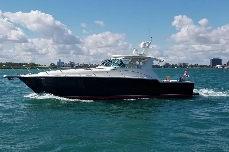 The Image of 1996 Tiara Yachts 4300 Open cruising on a sunny day with city skyline backdrop. - 0