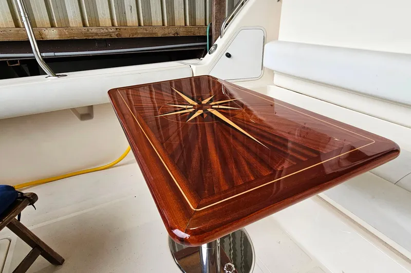 Slide: The Image of Luxurious wooden table with compass rose design on 1996 Tiara Yachts 4300 Open. - 12
