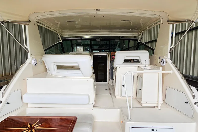 Slide: The Image of 1996 Tiara Yachts 4300 Open interior with white seating and wooden table. - 14