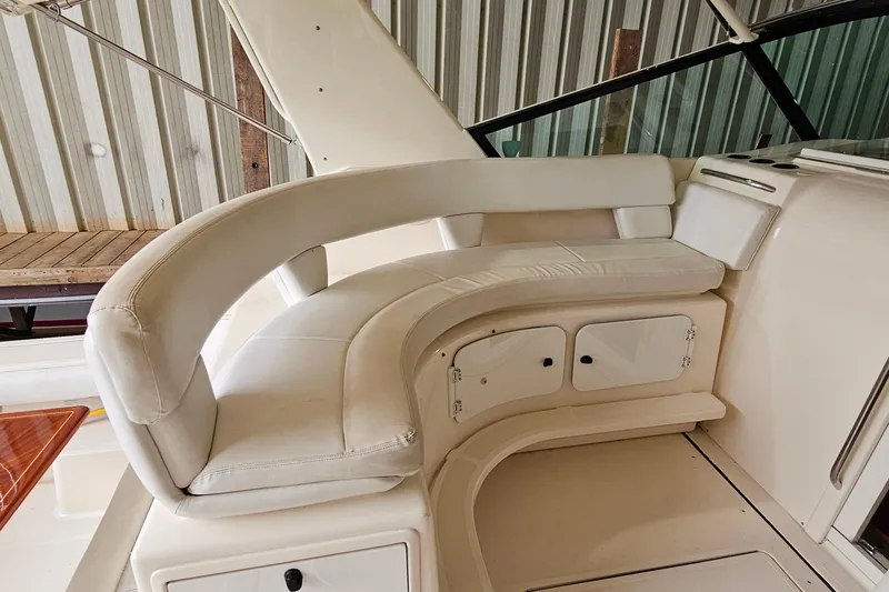 Slide: The Image of 1996 Tiara Yachts 4300 Open interior with curved white seating and storage compartments. - 16