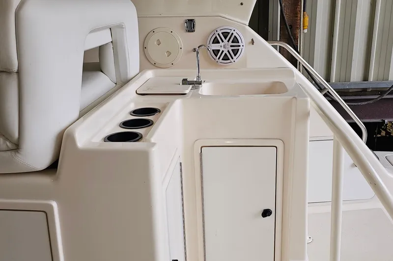 Slide: The Image of 1996 Tiara Yachts 4300 Open interior with sink, cup holders, and speaker. - 17