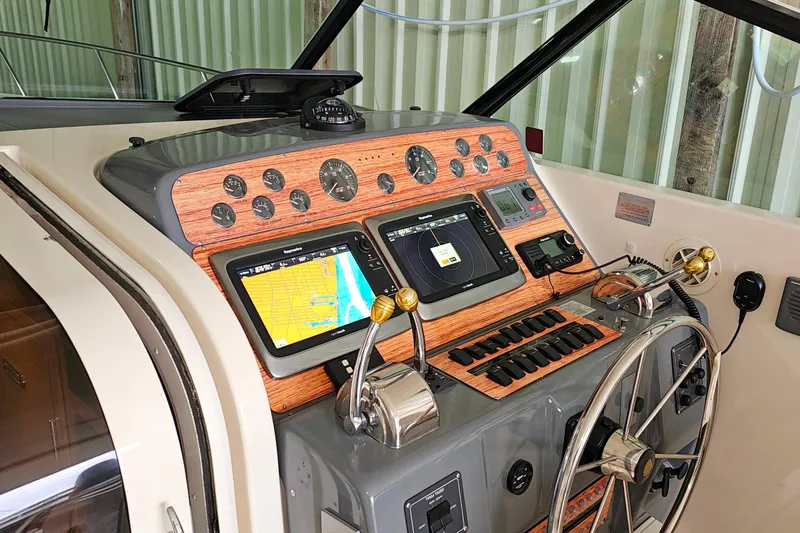 Slide: The Image of 1996 Tiara Yachts 4300 Open helm with navigation screens and controls. - 19