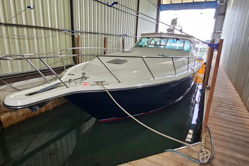 Slide: The Image of 1996 Tiara Yachts 4300 Open docked in a covered marina. - 2