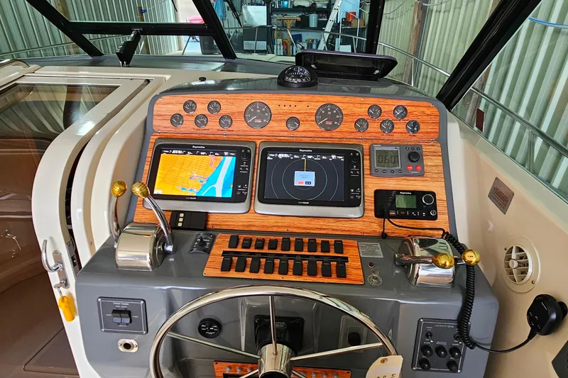 Slide: The Image of 1996 Tiara Yachts 4300 Open helm with navigation screens and control panel. - 20