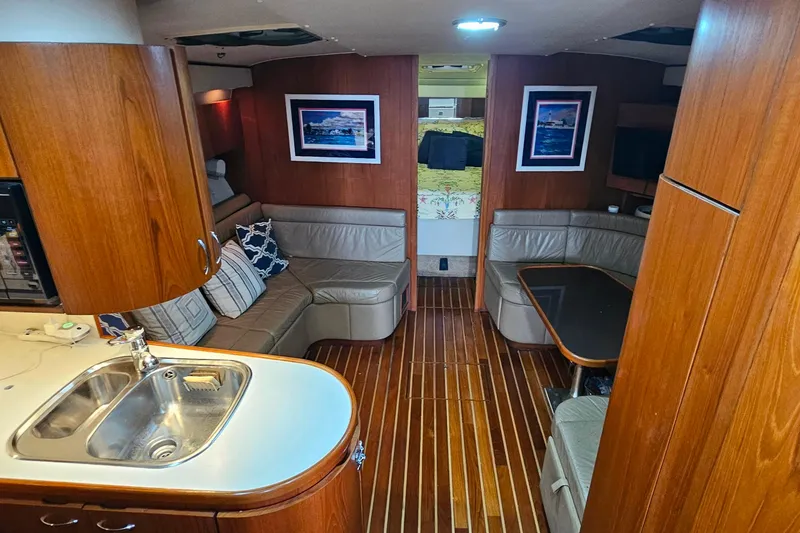Slide: The Image of Luxurious interior of a 1996 Tiara Yachts 4300 Open with wood finishes and cozy seating. - 23