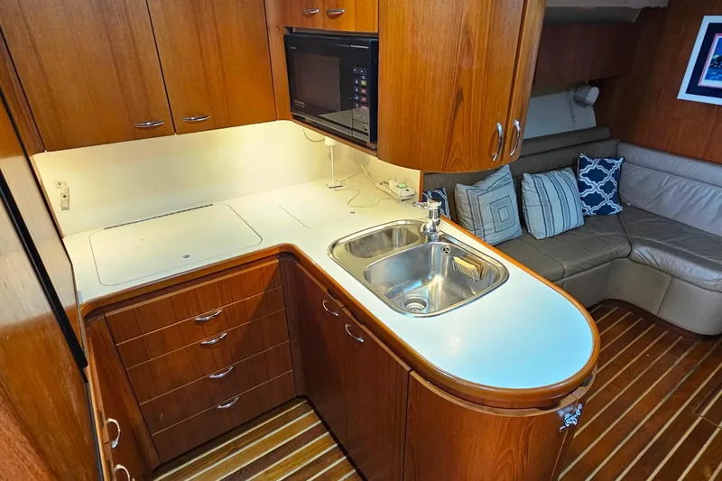 Slide: The Image of Cozy 1996 Tiara Yachts 4300 Open interior with kitchenette and seating area. - 24