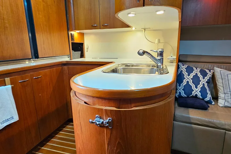 Slide: The Image of Luxurious 1996 Tiara Yachts 4300 Open interior with elegant wood cabinetry and modern kitchen amenities. - 29