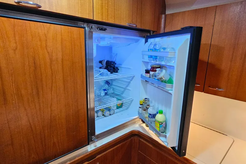 Slide: The Image of Open refrigerator in 1996 Tiara Yachts 4300 Open, stocked with drinks and condiments. - 31