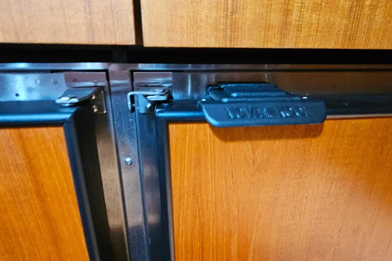 Slide: The Image of Close-up of a Nova Kool latch on a Tiara Yachts 4300 Open, 1996 model. - 32