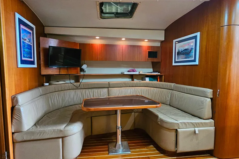 Slide: The Image of Luxurious interior of 1996 Tiara Yachts 4300 Open with cozy seating and elegant wood finish. - 33