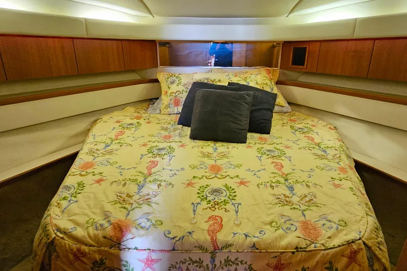 Slide: The Image of Cozy bedroom in 1996 Tiara Yachts 4300 Open with nautical-themed bedding. - 34