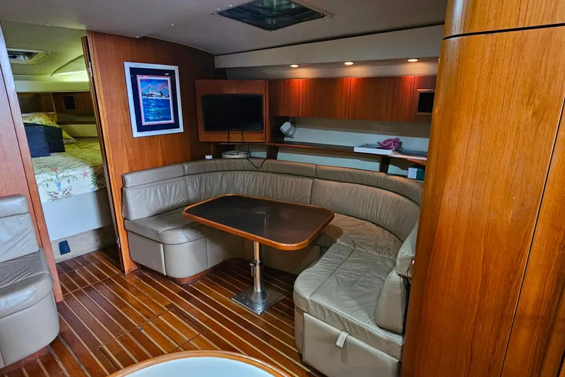 Slide: The Image of Interior of a 1996 Tiara Yachts 4300 Open with cozy seating and wooden finishes. - 36
