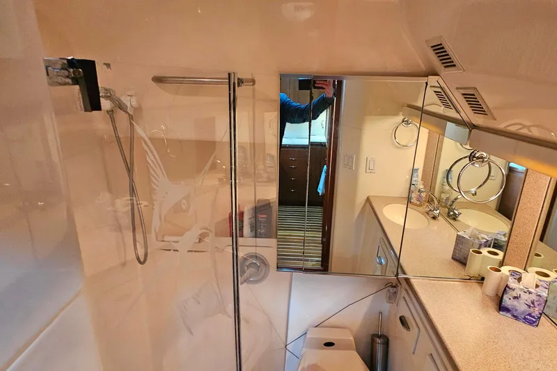 Slide: The Image of Bathroom interior of a 1996 Tiara Yachts 4300 Open, featuring a shower and vanity. - 38