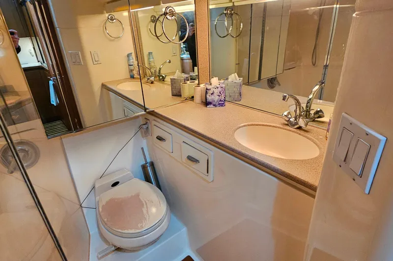 Slide: The Image of Bathroom interior of 1996 Tiara Yachts 4300 Open, featuring sink and toilet. - 39