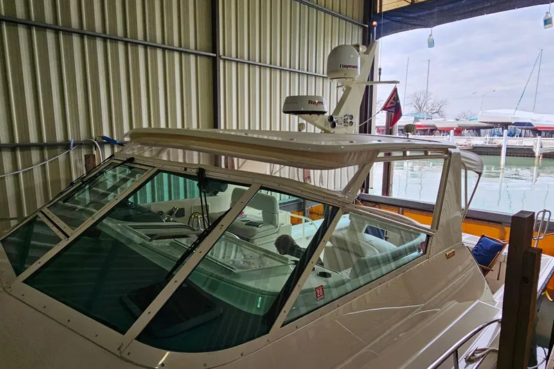 Slide: The Image of 1996 Tiara Yachts 4300 Open docked in a marina, featuring Raymarine equipment. - 42