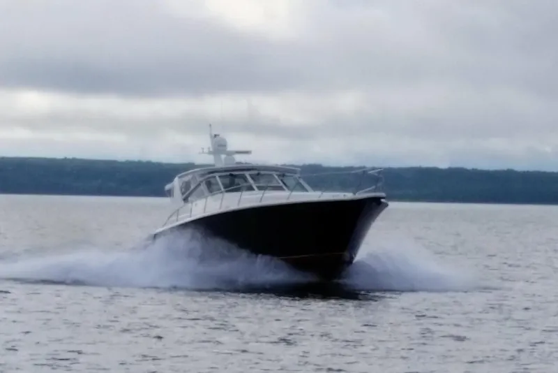 Slide: The Image of 1996 Tiara Yachts 4300 Open cruising on a cloudy day. - 44