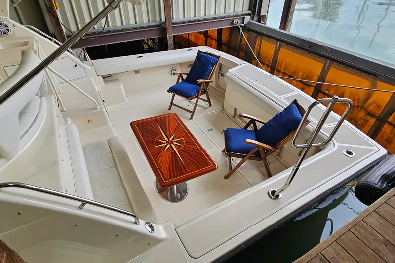 Slide: The Image of 1996 Tiara Yachts 4300 Open cockpit with elegant seating and wooden table. - 7