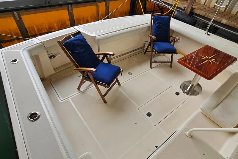 Slide: The Image of 1996 Tiara Yachts 4300 Open deck with chairs and a wooden table. - 8