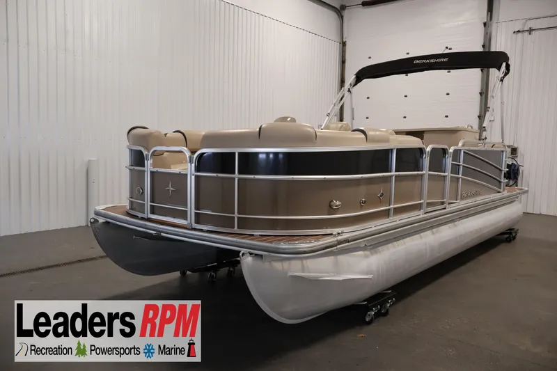 The Image of 2016 Berkshire 23E STS pontoon boat in indoor showroom, Leaders RPM logo visible. - 1