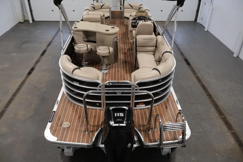 Slide: The Image of 2016 Berkshire 23E STS pontoon boat with beige seating and wood-style flooring. - 10