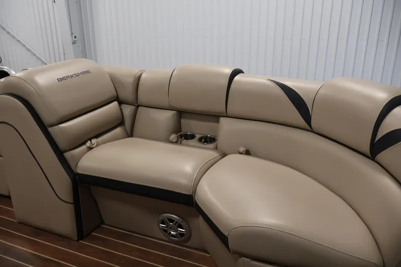 Slide: The Image of 2016 Berkshire 23E STS boat interior with beige leather seating and cup holders. - 12