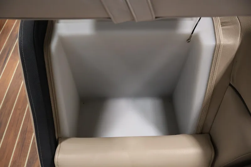 Slide: The Image of Storage compartment in 2016 Berkshire 23E STS boat with beige interior. - 13