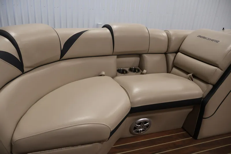 Slide: The Image of Luxurious beige seating in 2016 Berkshire 23E STS boat with cup holders and speaker. - 15