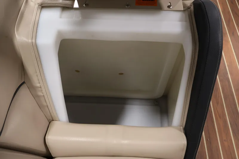 Slide: The Image of Open storage compartment in 2016 Berkshire 23E STS boat with beige seating. - 16